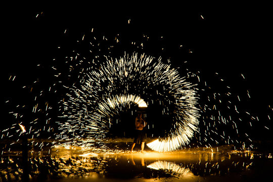 THAILAND - APRIL 08, 2019: Beautiful Fire Show in night on the Beach, Lively night with dancing amazing fire show, Koh Samed island in Thailand