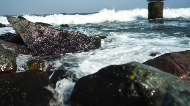 Sea waves crashing against the rocks. Dueodde strand, Denmark.