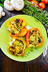 Pepper stuffed with mushrooms in plate on board top