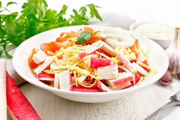 Salad of surimi and tomatoes on board