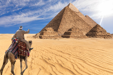 A bedouin of Giza desert in front of the Great Pyramids, Egypt