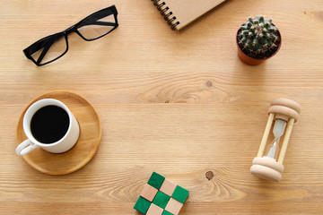 Open notebook with empty pages over wooden old office desk table. Top view, flat lay