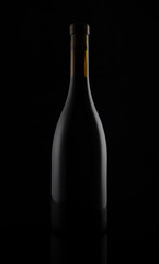 Isolated black matt wine bottle on dark background