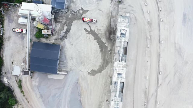 Top down forward aerial of a cement truck backing up to a mixing station for loading. Location Blekinge in Sweden.