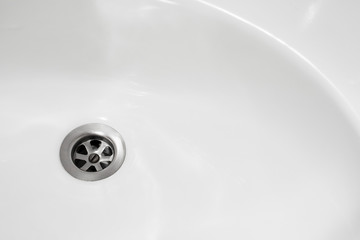 View of the sink drain. Close up photo of water drain. plumbing in bathroom.