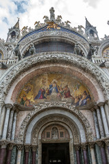 Fototapeta na wymiar Italy. The Cathedral of the Sacred Mark - the cathedral of Venice. Fragments of the decoration of the main facade.