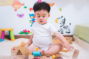 Child boy building playing toy blocks wood