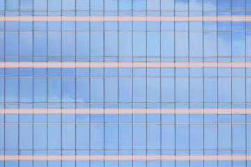 modern office building elevation. glass curtain wall repeating pattern reflecting cloud in the sky. city people in the architectural box.