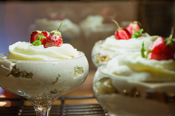 Dessert with strawberries. Delicate cream, slices of sponge cake with strawberries.