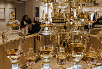Beautiful vintage style bottles of parfum selling on tap in store.
