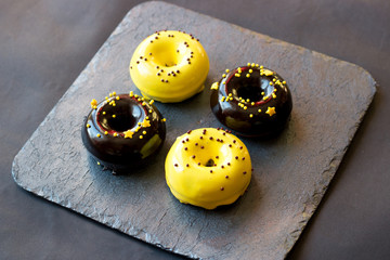 donuts in a glaze mix on a graphite stand