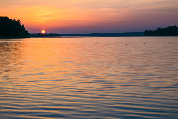 Fototapeta premium Sunrises sunsets on a summer pond in the forest