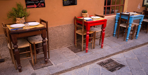 SESTRI LEVANTE, ITALY, MAY 31, 2019 - Tables set in a typical Italian outdoor restaurant in Sestri Levante, province of Genoa, Italy.