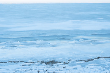 Naklejka na ściany i meble texture of frozen snow. beautiful background of blue snow and ice
