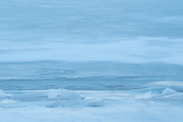 Naklejka na ściany i meble texture of frozen snow. beautiful background of blue snow and ice
