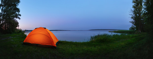 Orange tent by the lake