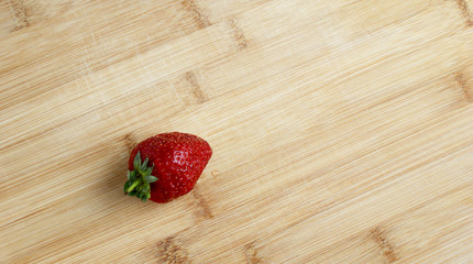 red ripe large strawberries on a wooden table