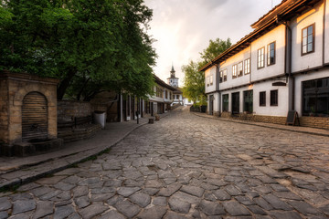 First light above the old street / Morning view with an old street in the revival architectural complex in Tryavna, Bulgaria