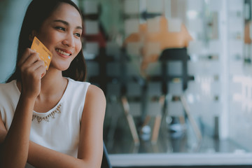 asian woman with credit card for shopping online.