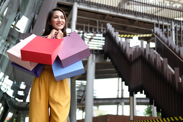 woman holding shopping bags. consumerism lifestyle in mall