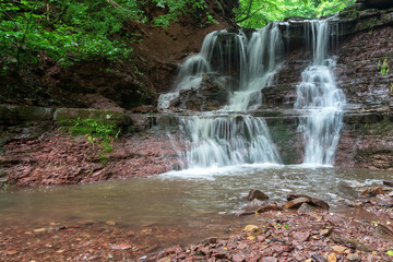 Fototapeta na wymiar Mountain river waterfall landscape. Cascade of Dzhurynskyi waterfall.