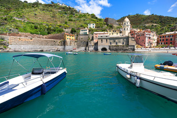 View on bay of water with moored boats, country town Vernazza, Cinque Terre, Italy