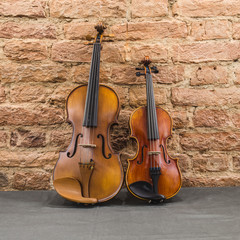 Fototapeta na wymiar two violins on stone backgroynd