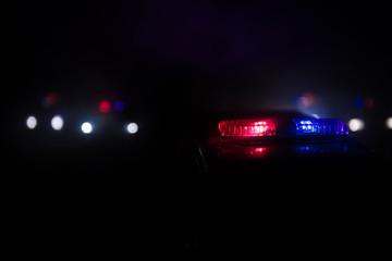 Fototapeta na wymiar Police cars at night. Police car chasing a car at night with fog background. 911 Emergency response pSelective focus