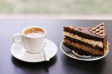 a cup of coffee and a piece of cake