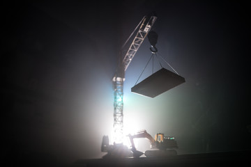 Abstract Industrial background with construction crane silhouette over amazing sunset sky. Tower crane against the evening sky. Industrial skyline