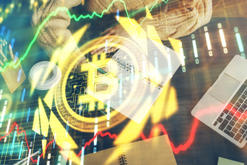 Cryptocurrency hologram over hands taking notes background. Concept of blockchain. Multi exposure