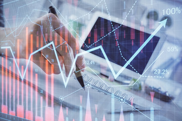 Financial forex graph drawn over hands taking notes background. Concept of research. Multi exposure