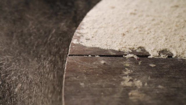 Slow motion. Wood sawdust on the wooden table