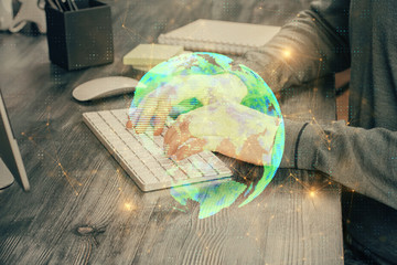 Social network theme hologram with businessman working on computer on background. Concept of world wide web. Multi exposure.