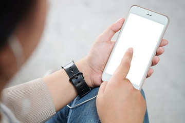 Cropped shot view of man hands holding smart phone with blank copy space screen for your text message or information content, female reading text message on cell telephone during in urban setting. 