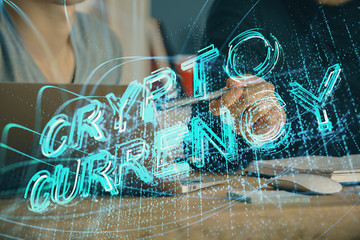 Crypto currency theme hologram with businessman working on computer on background. Concept of...