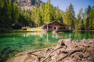 Fototapeta na wymiar The lodge over the turquoise waters of Lago Ghedina, an alpine lake in Cortina D'Ampezzo, Dolomites, Italy