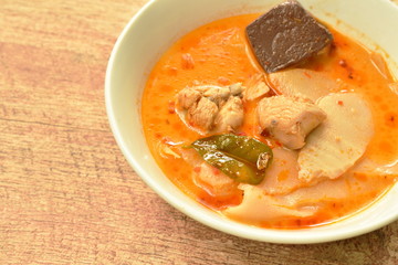 spicy boiled slice pickled bamboo shoot with chicken and blood in coconut milk curry soup on bowl