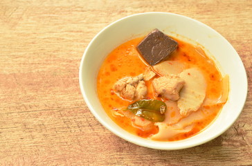 spicy boiled slice pickled bamboo shoot with chicken and blood in coconut milk curry soup on bowl