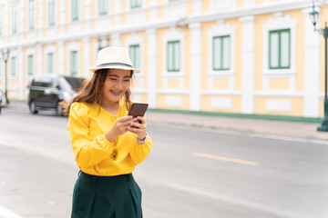 Fototapeta premium Happy tourist woman used smart phone for searching the street locations