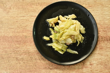 stir fried slice cabbage and pork with fish sauce on plate