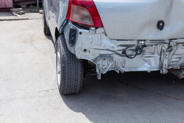 Closeup back of silver car get damaged by accident on the road.