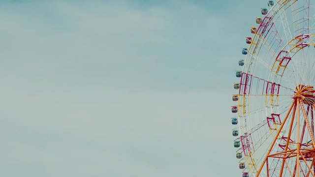 Design Layout or template for video editing. A huge ferris wheel on a background of blue sky.
