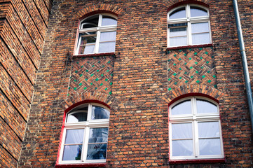 Detale architektoniczne, mozaikowy mur z cegieł z oknami, w domach dzielnicy kopalnianej.