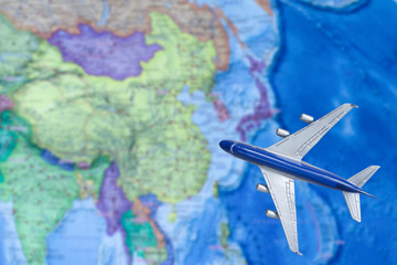 Fototapeta na wymiar Toy plane on the map. Air trip to China. Travel by plane, booking tickets, flight by aircraft concept