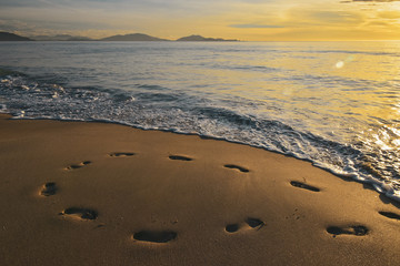 footprints in the sand from the feet of a lost person. no way out of the situation. return to the be