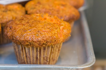 Deliciously baked Muffins waiting to be sold in a spnish bakery. tasty and sweet brown pastry.