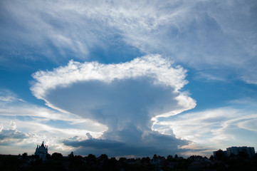 amazing rare white cloud in the blue sky. Sunset over the city