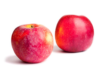 Two red ripe juicy apples on white isolated background