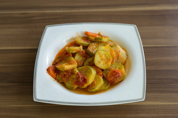 olive oil zucchini food in the white plate on the wooden table for restaurant or kitchen concept.